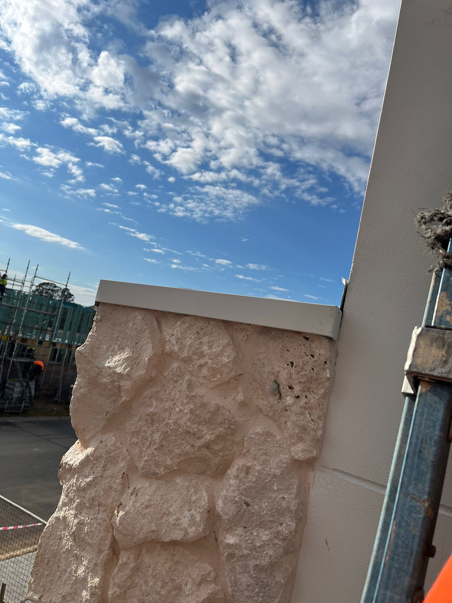 Stone pillar construction with scaffolding